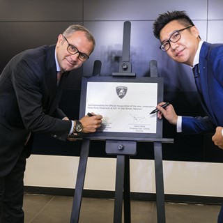 Mr. Stefano S. Domenicali and A. Wong sign the commemoration plaque